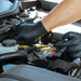 mechanic using the Advance IF 51 Black 5 Mil Nitrile Exam Gloves to fix the car